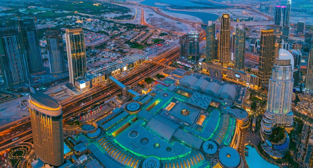 Aerial View Of Evening Night Scenic View Of Skyscraper. Night Traffic In Residential District in Dubai. Street Night Illumination. Night Scenic View Of Dubai Skyline. High quality photo.